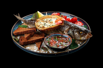 Seabass with spinach and cream sauce. On a black background