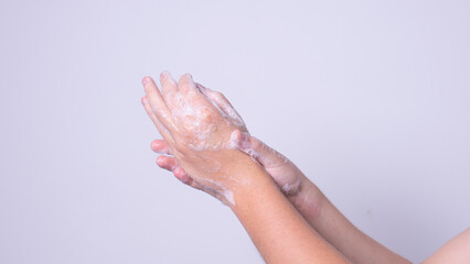 the man washes his hands with soap