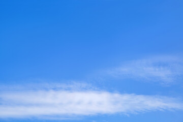 Blue sky with white fluffy cirrus clouds soft focus. Heavenly clouds background summer. Concept of freedom, relaxation, ecology. Copy space. Empty space..