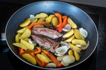 the roasted tenderloin from the red deer calf with fries potatoes and roasted onions is a delicious meal