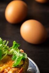 Aerial view of mushroom quiche with lamb's lettuce and brown eggs, with selective focus, vertical