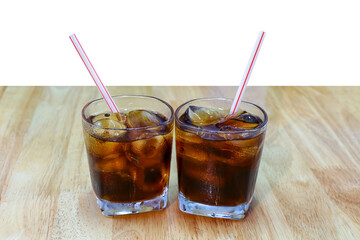cola glass on table plank, cola with ice cubes in the glass
