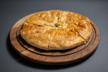 georgian khachapuri with mushrooms and potato or cheese pie on wooden board