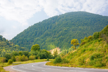 mountain road through countryside on a cloudy morning. beautiful landscape in september