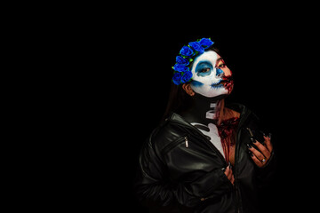 Halloween costume and makeup. Portrait of Calavera Catrina Zombie. Portrait of a woman with a painted face.