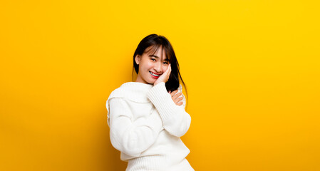 happy everyday picture of a happy girl standing on a yellow background Looking at the camera and smiling happily