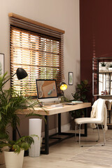 Light room interior with comfortable workplace near window