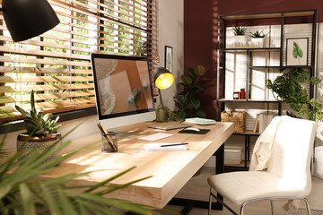Light room interior with comfortable workplace near window