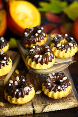 Pumpkin muffins with chocolate. Autumn dessert composition.