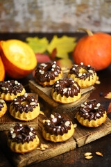 Pumpkin muffins with chocolate. Autumn dessert composition.