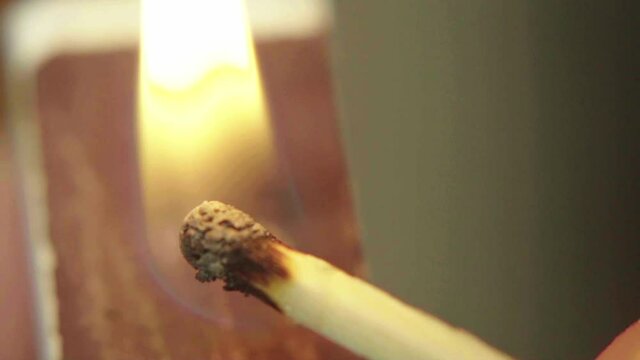 Close-up of a burning match
