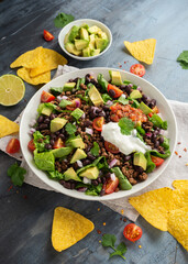 Beef Taco salad with romaine lettuce, avocado, tomato salsa, black bean and tortilla chips. Mexican...