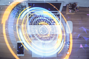 Technology hologram drawing over computer on the desktop background. Top view. Double exposure. Tech concept.