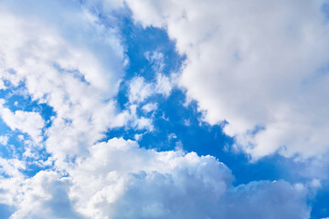 Obraz premium Blue sky with white cumulus clouds. Banner. Background. Nature wallpaper. Sunny weather forecast. Religion concept. Heaven landscape. Outdoor scenic. Bright pattern design. Copy space. Fresh air