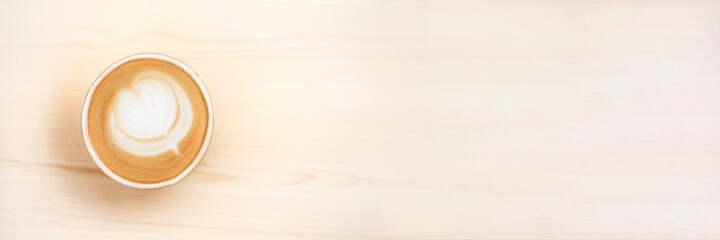 Web banner with fresh flavored coffee art is on the wooden table.
