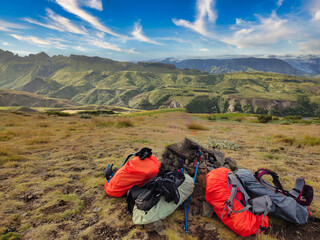 Fototapeta premium Backpacks placed on hill in mountains
