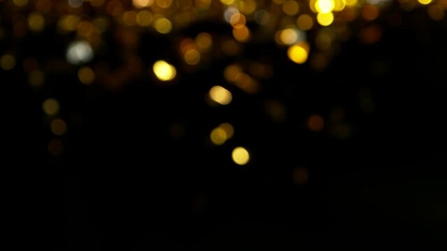 Super slow motion of abstract gold particles on black background. Filmed on high speed cinematic camera at 1000 frames per second.