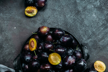 Ripe blue plums on a dark background