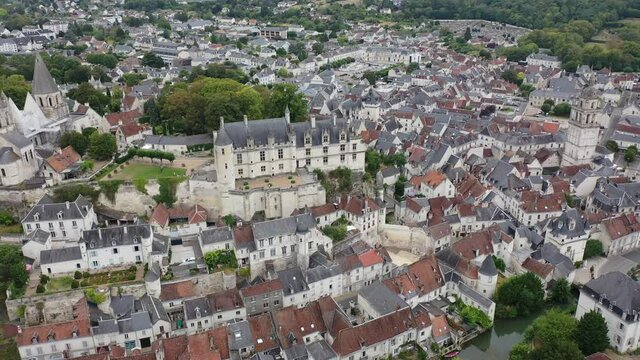 Scenic drone view of medieval fortified castle with royal residence and St Ours church in historic French town of Loches in summer
