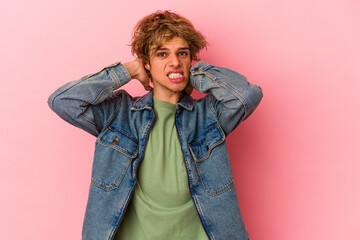 Young caucasian man with make up isolated on pink background screaming with rage.