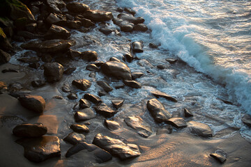 Aerial view of sea waves and rocky coast. Stones by the sea.