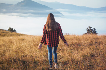 Teenage Girl Walking in Foggy Mountain Landscape