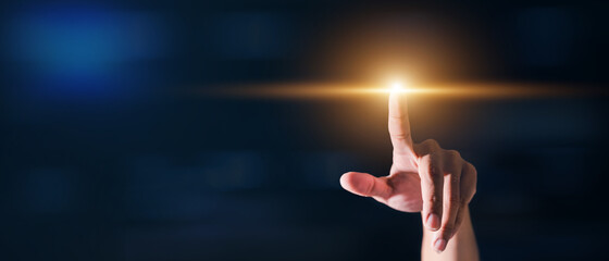 The hands of business people are touching the technology of the future on black backdrop.  There is...