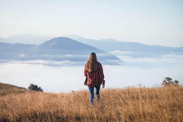 Young Girl Walking in Foggy Mountain Landscape