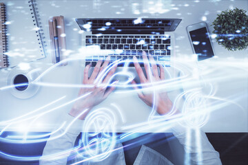 Double exposure of woman hands working on computer and car hologram drawing. Top View. Auto pilot concept.