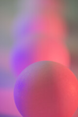 Balls in pink and purple light.
