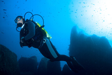 Diver over underwater mountains. Mediterranean sea.
