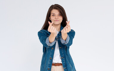 Speading love and happiness. European girl showing heart sign