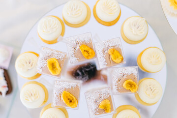 Stylish beautiful luxurious sweet candy bar on a table at a wedding ceremony in a restaurant. Confectionery business concept
