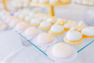 Fototapeta na wymiar luxury wedding table with modern white desserts in the shape of a heart.