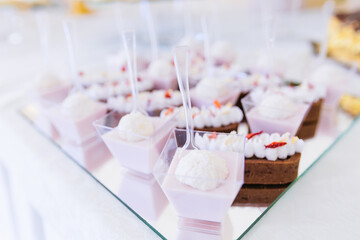 Candy bar decorated with a delicious sweet buffet with cupcakes and other desserts for birthday and wedding.