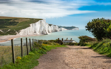 Sussex Coastline, UK. The rugged coast of South England looking over Cuckmere Haven and the Seven Sisters white chalk cliffs to the English Channel. - 456704599