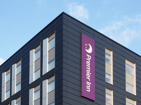 logo and banner sign on the corner of a premier inn hotel on whitehall road in leeds