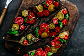 Obraz na płótnie Canvas Baked eggplant appetizer with tomatoes and cheese