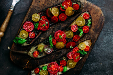 Obraz na płótnie Canvas Baked eggplant appetizer with tomatoes and cheese