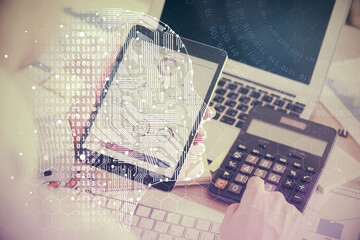 Double exposure of man's hand holding and using a digital device and brain hologram drawing. Data concept.