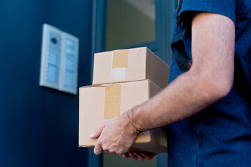 Close up of delivery man delivering parcel box. Courier service concept. horizontal view of...