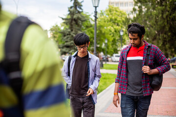 Obraz premium Two multiracial male best friends meeting outdoors