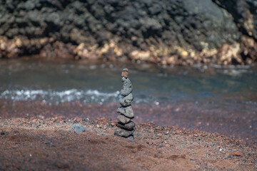 Balancing pyramid of sea pebbles on a beach background, the concept of harmony and balance. Stones balancing.