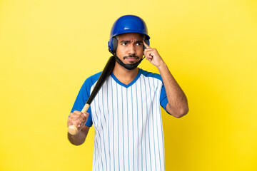 Young Colombian latin man playing baseball isolated on yellow background having doubts and thinking
