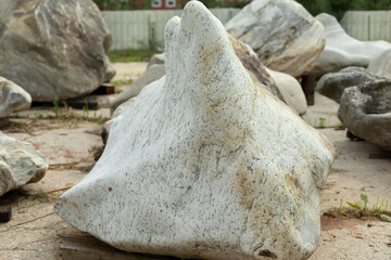 Beautiful stone to decorate the park. The rock is prepared for installation. A large boulder of interesting shape.
