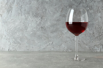 Glass of red wine on gray textured table