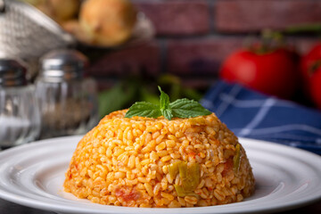 Traditional turkish bulgur pilaf with tomato sause in plate (Turkish name; meyhane pilavi)
