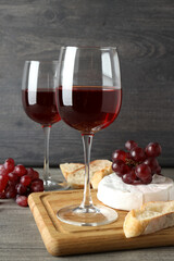 Concept of tasty eating with red wine on gray textured table