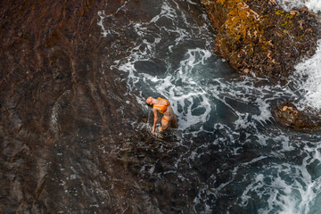 Sexy woman in sea near the waves. Top view, aerial Shooting.