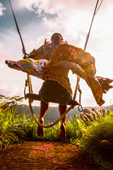 Woman on a swing in a fluttering dress